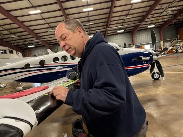Aircraft engine being inspected by a Penn Air Repair technician